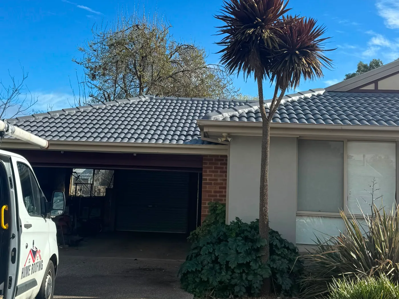 Hume Roofing completed roof restoration with branded service vehicle