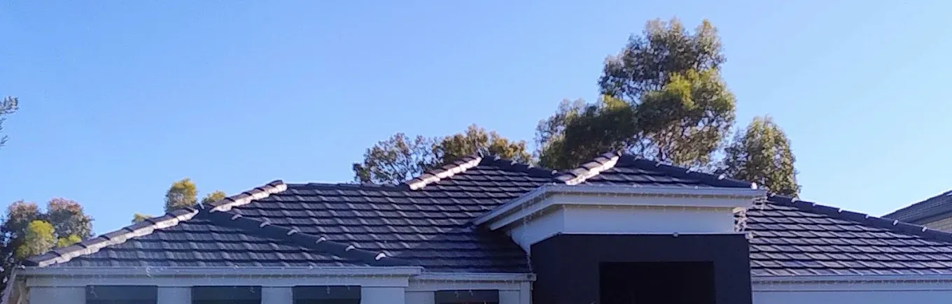 Completed dark tile roof restoration by Hume Roofing